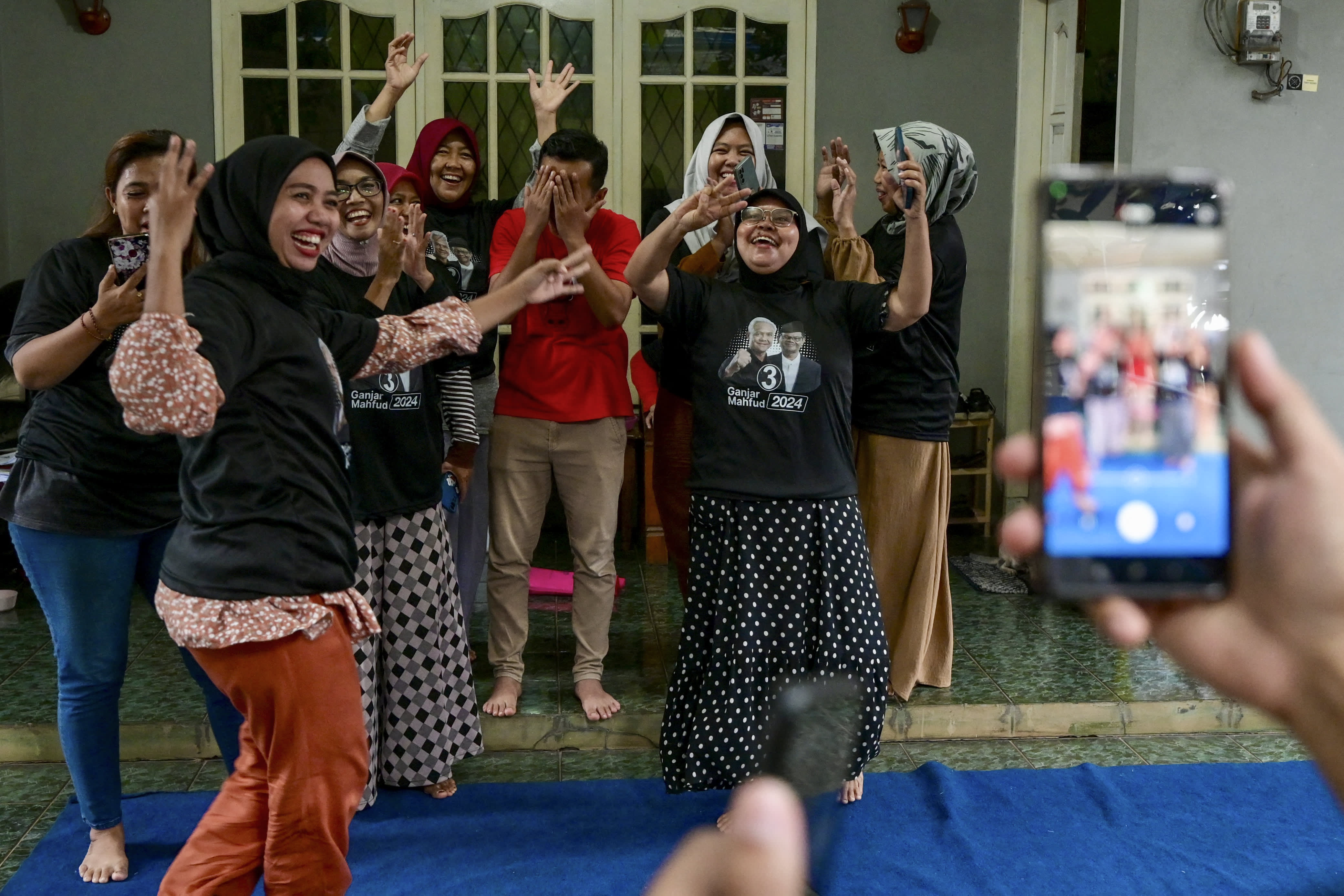 This picture taken on January 10, 2024 shows a man recording a campaign video for social media to be used by Ukon Furkon Sukanda, a legislative candidate of the Indonesian Democratic Party of Struggle (PDI-P), in Tangerang, Banten province.