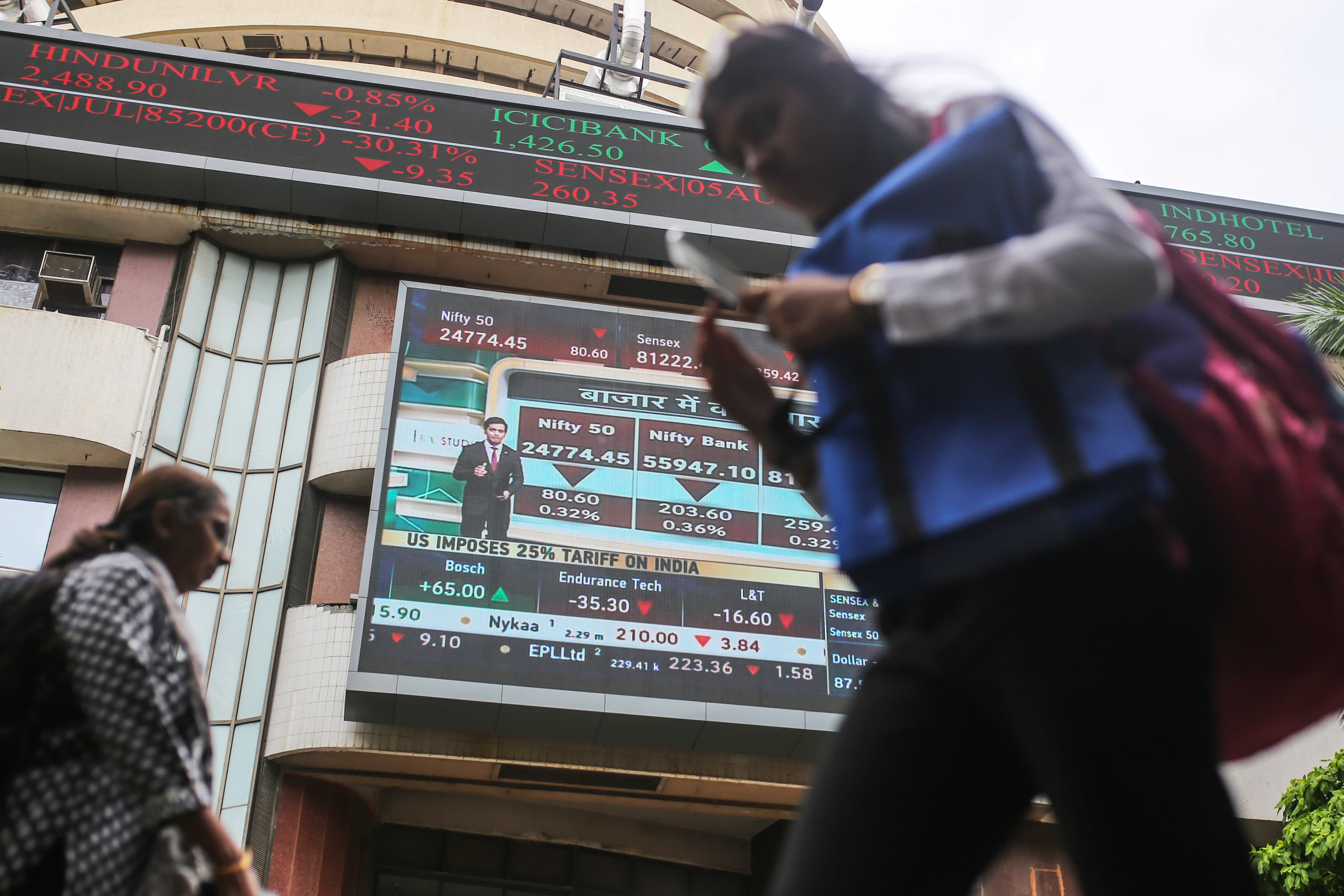 A ticker and a screen display stock prices at the Bombay Stock Exchange (BSE) building in Mumbai, India, on Thursday, July 31, 2025. Photographer: Dhiraj Singh/Bloomberg via Getty Images